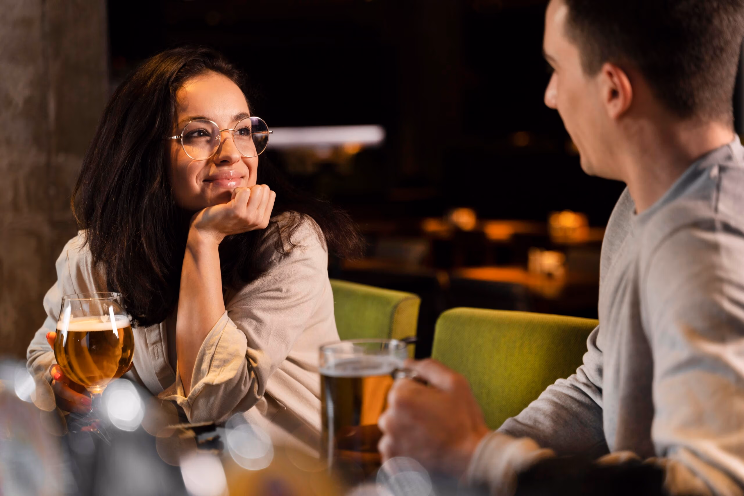Woman talking to man at bar