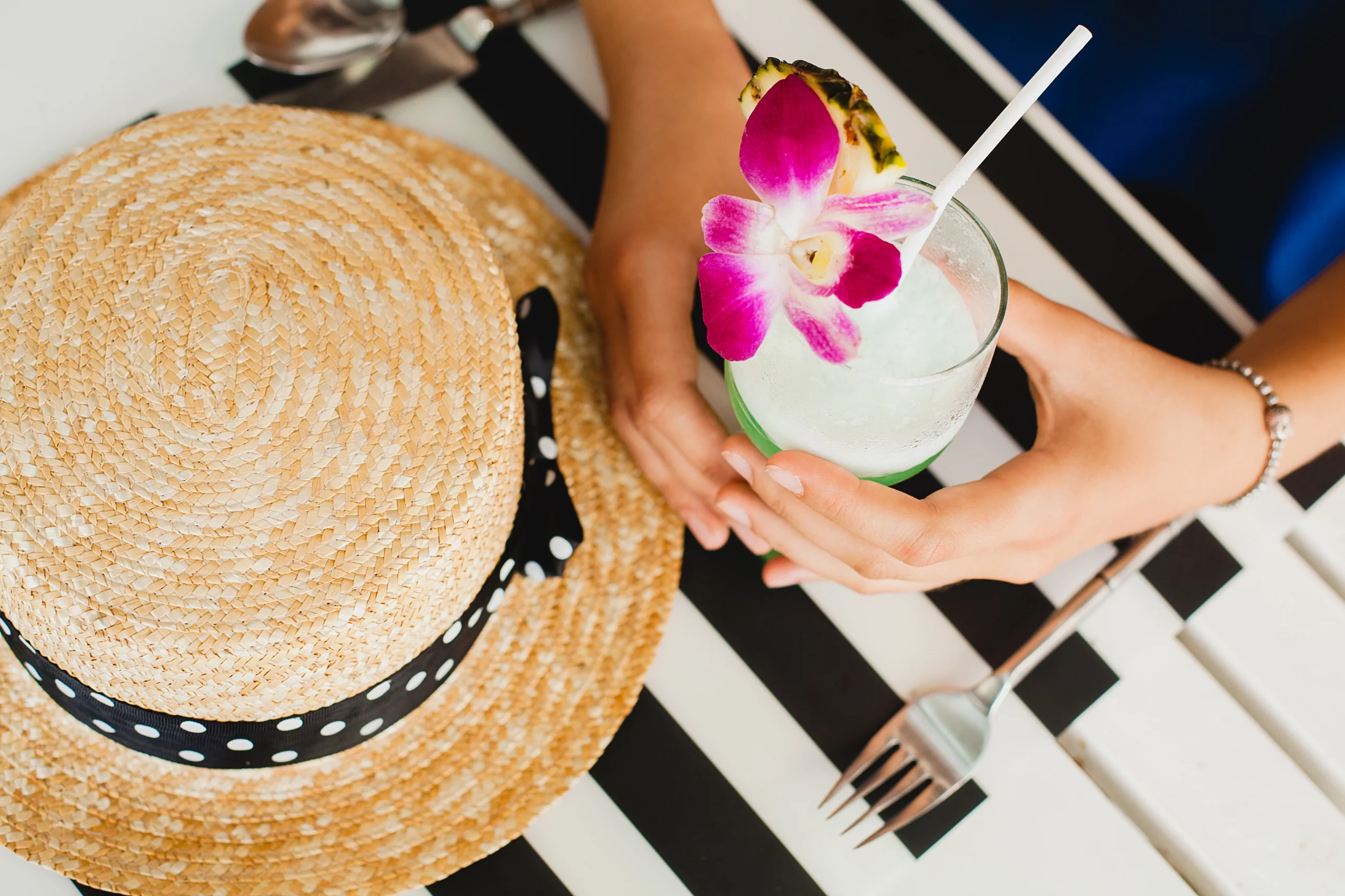 Attractive young woman blue dress straw hat wearing pink sunglasses drinking alcohol cocktail tropic - Pier 5 Attractive young woman blue dress straw hat wearing pink sunglasses drinking alcohol cocktail tropic