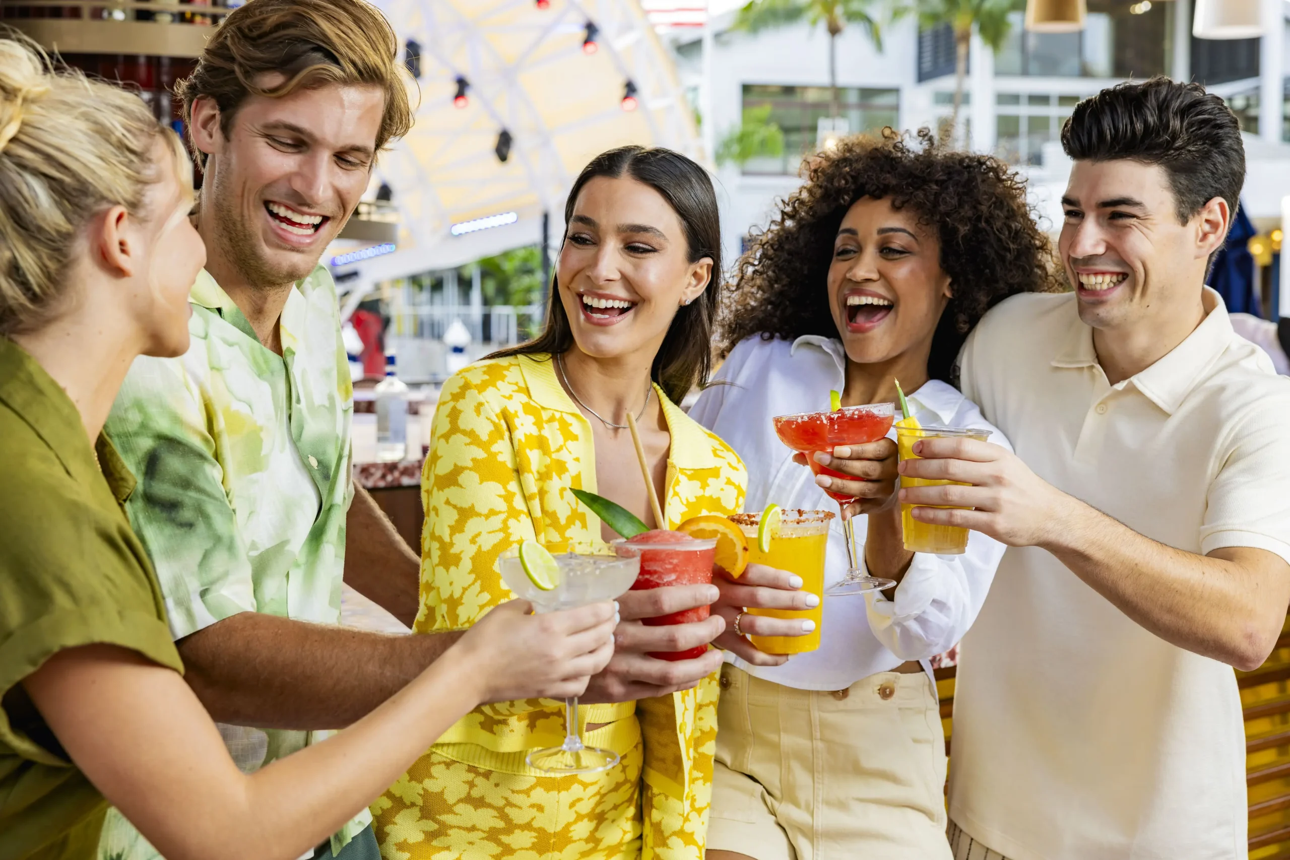 People doing a cheers with cocktails at Pier 5 - Pier 5 People doing a cheers with cocktails at Pier 5